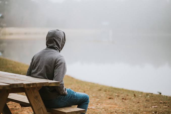 Person reflecting on energy levels during a quiet moment
